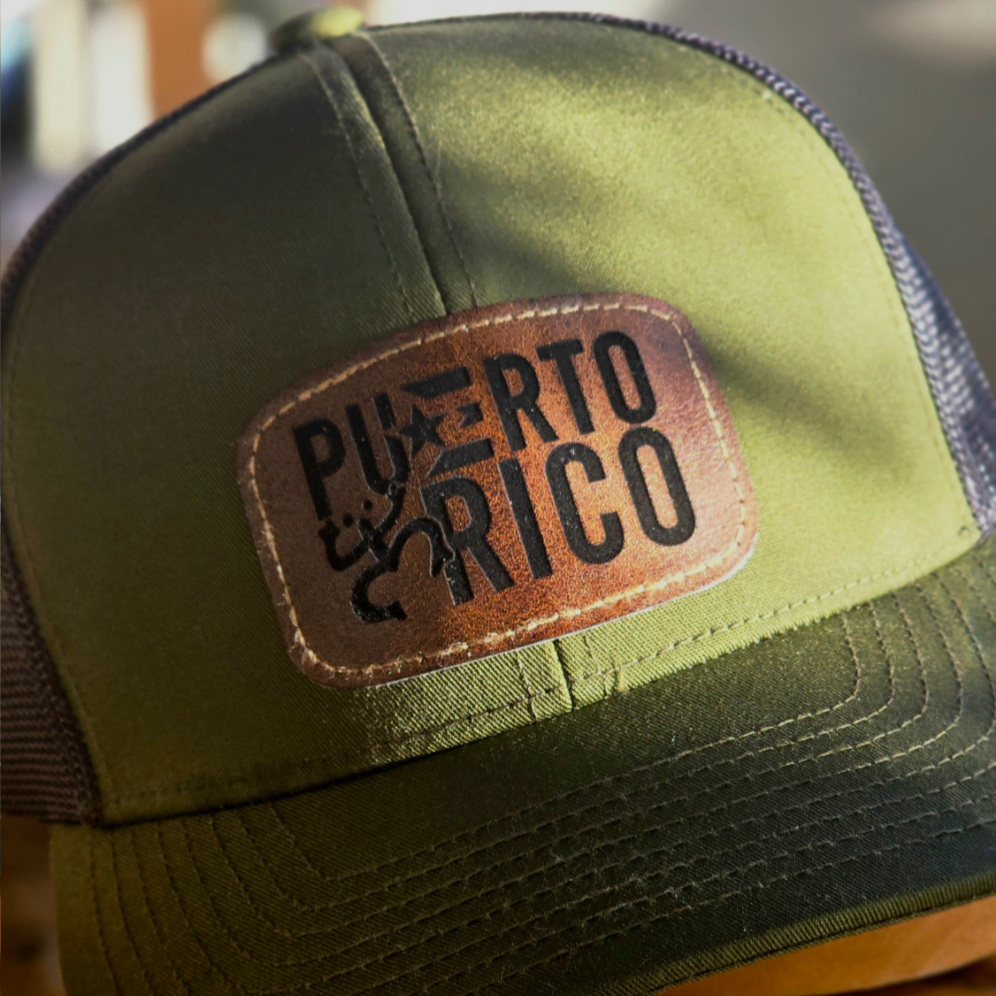 Green trucker hat with 'Puerto Rico' leather patch on a blurred background